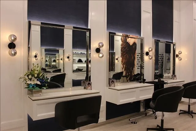 Salon styling stations with mirror lighting and power at Vogue Hair Bar